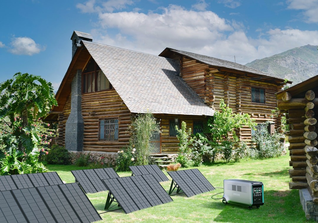 a log cabin with solar panels on the lawn